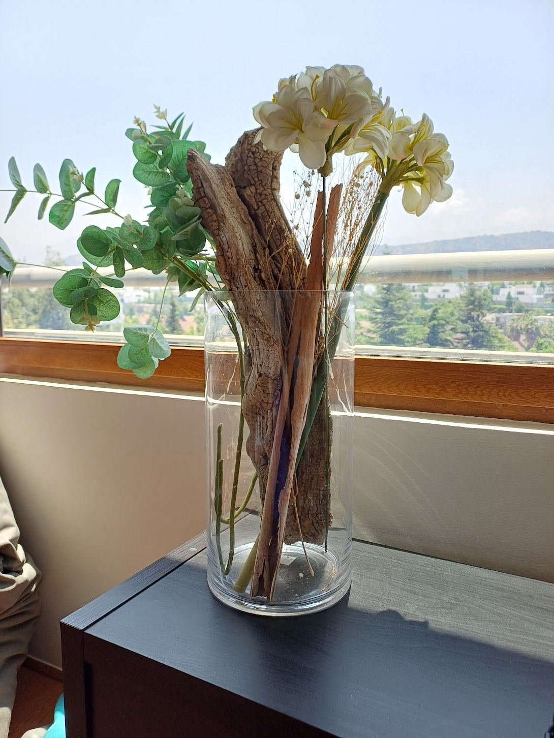 Florero vidrio con arreglo flores artificiales y ramas